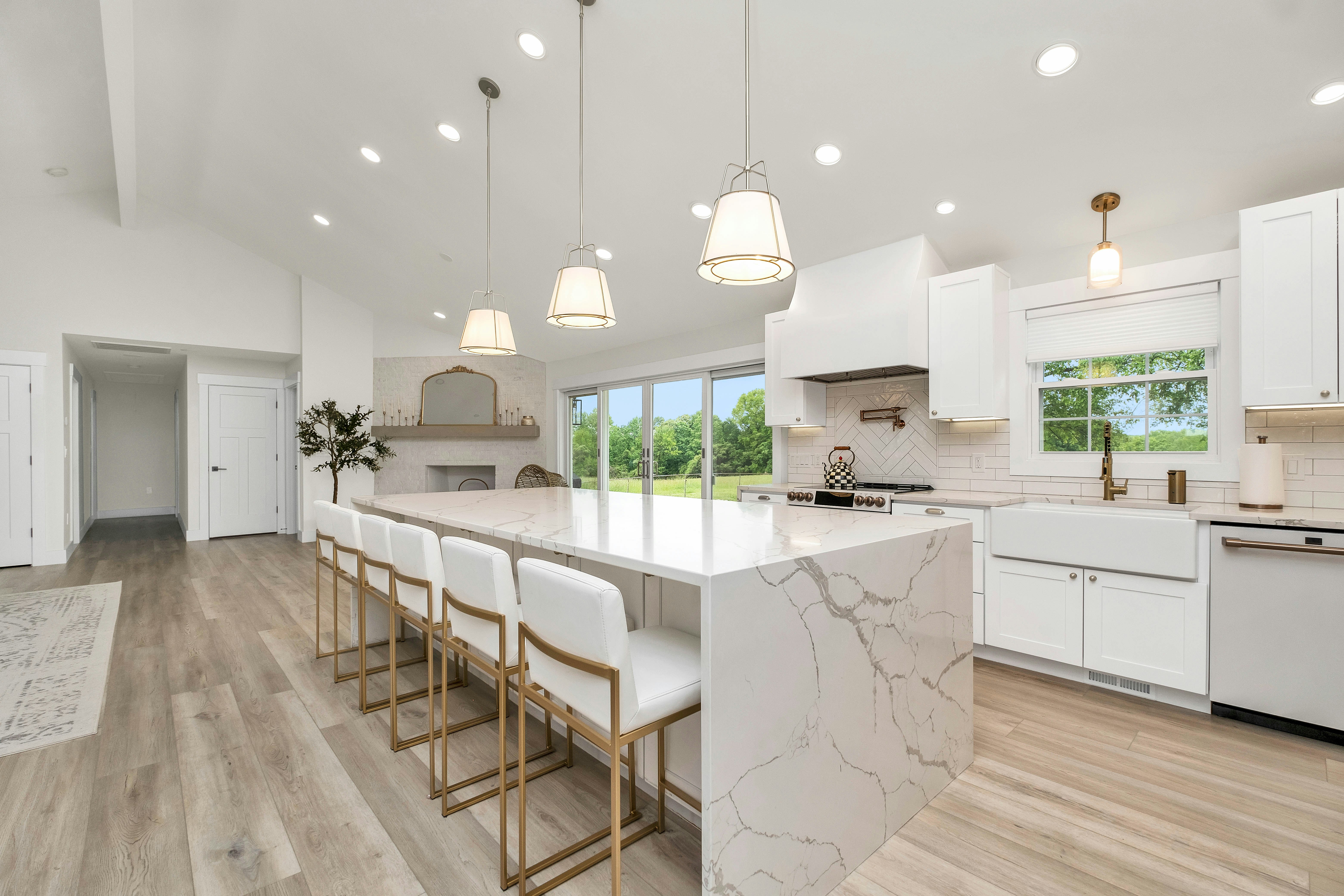 Modern kitchen with white cabinetry, large island, and pendant lighting