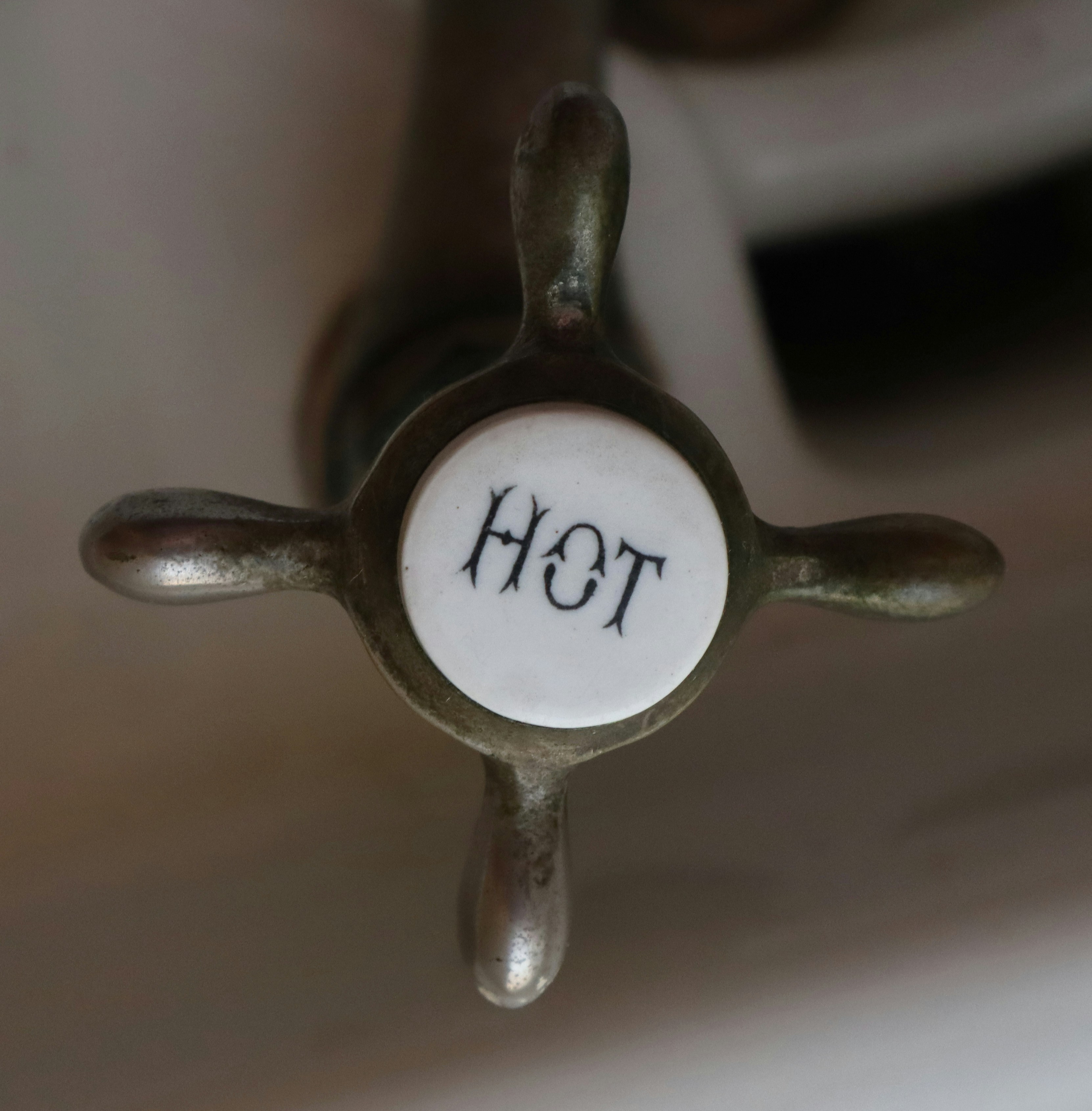Close-up of a vintage hot water faucet handle