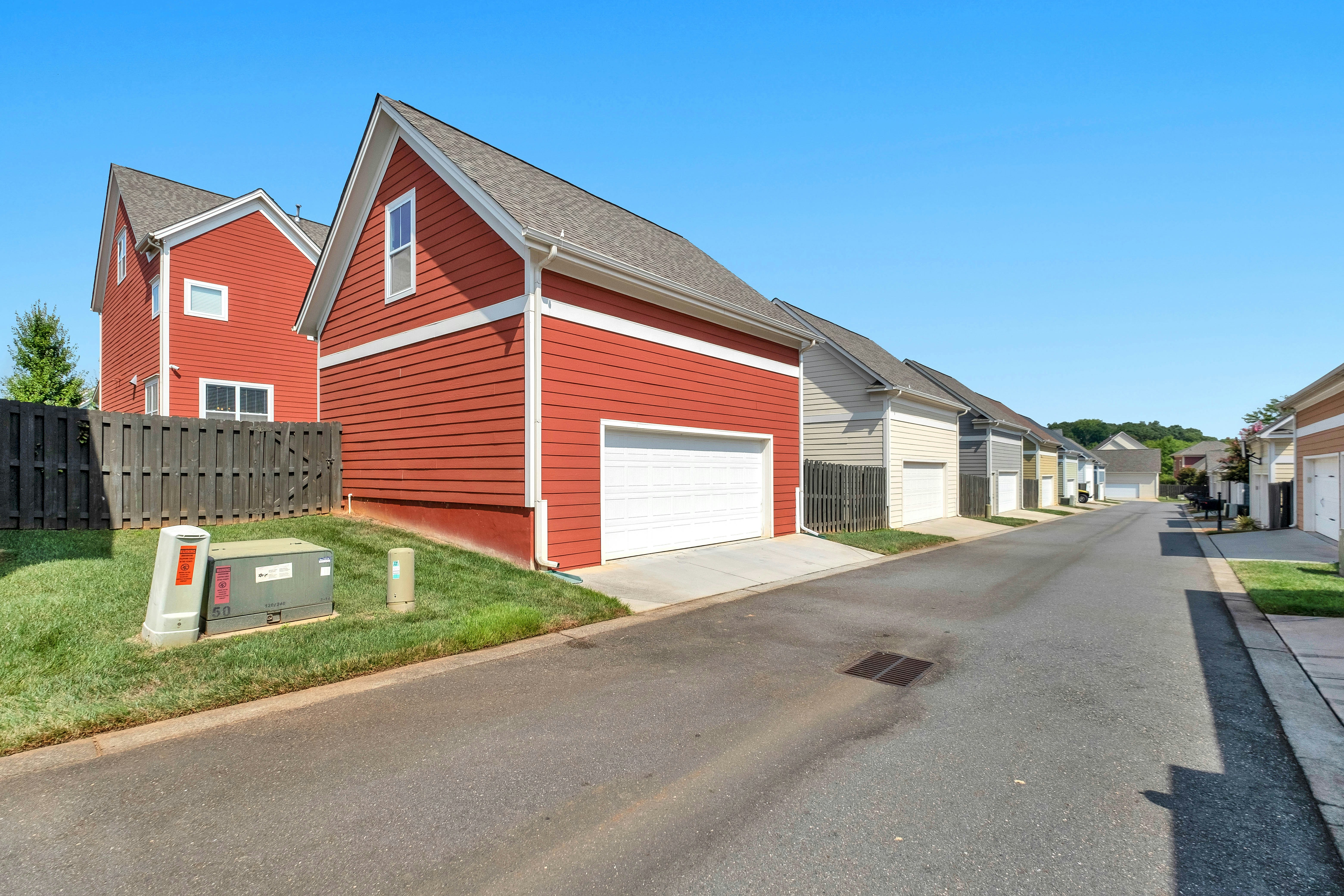 Suburban street with red and beige houses and garages